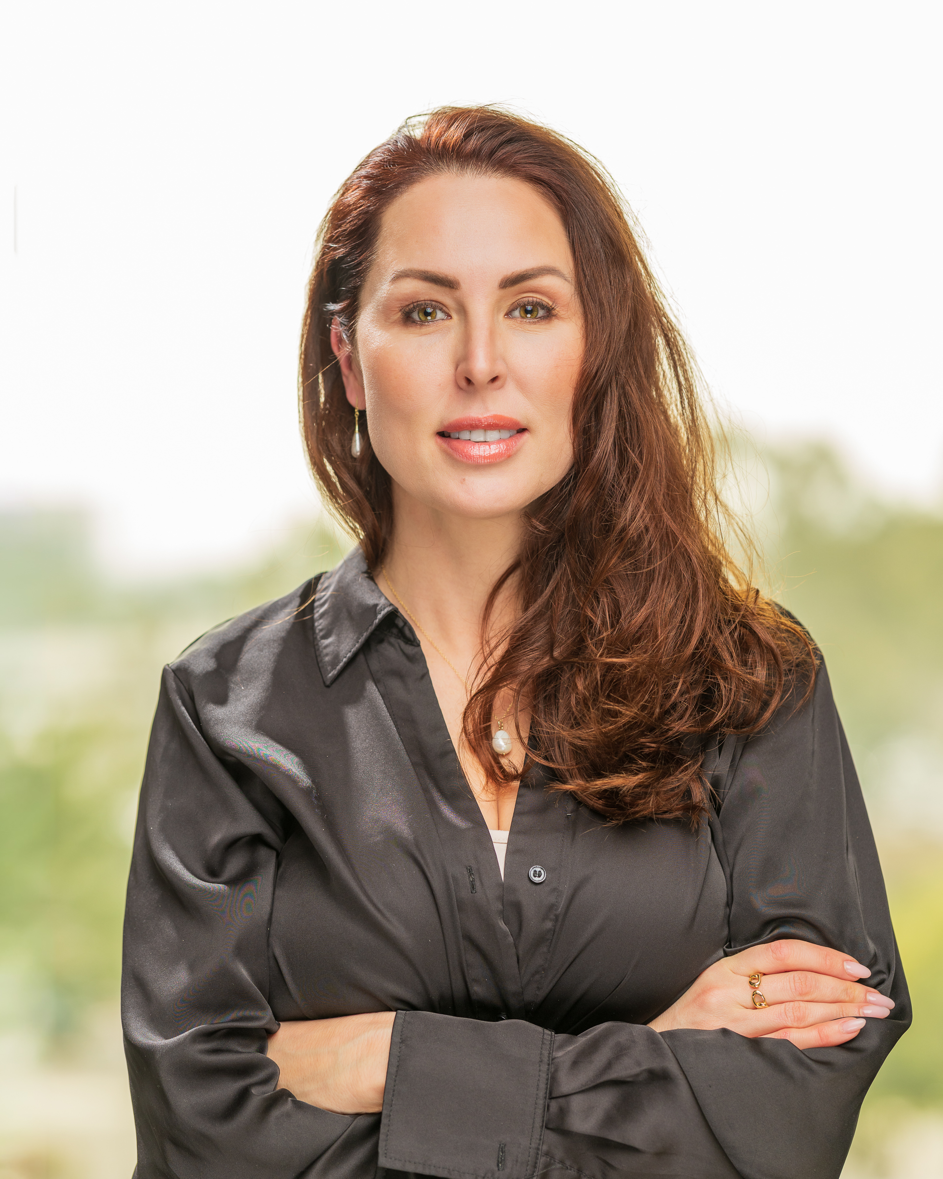 Confident woman in black shirt outdoors