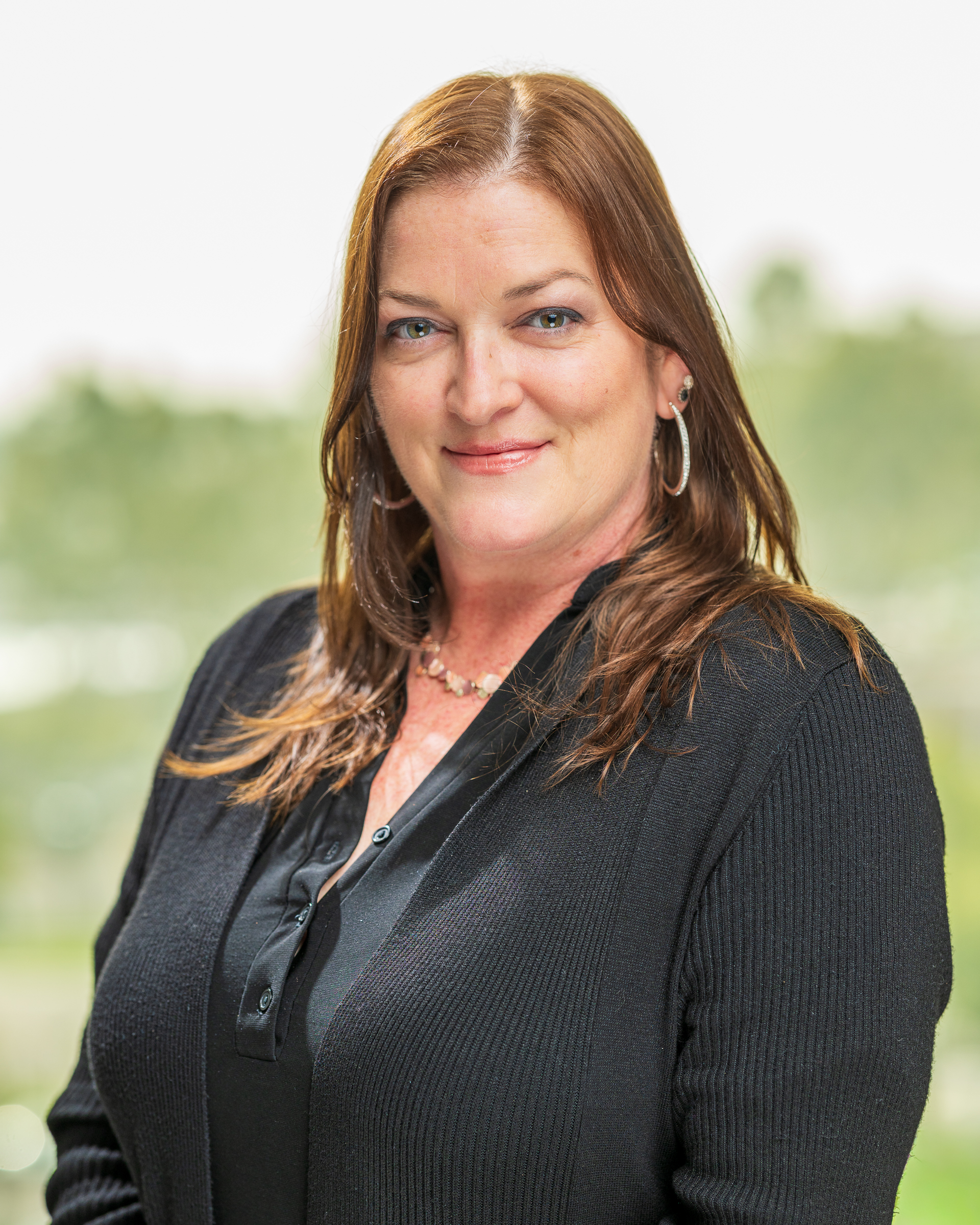 Smiling woman in black sweater outdoors