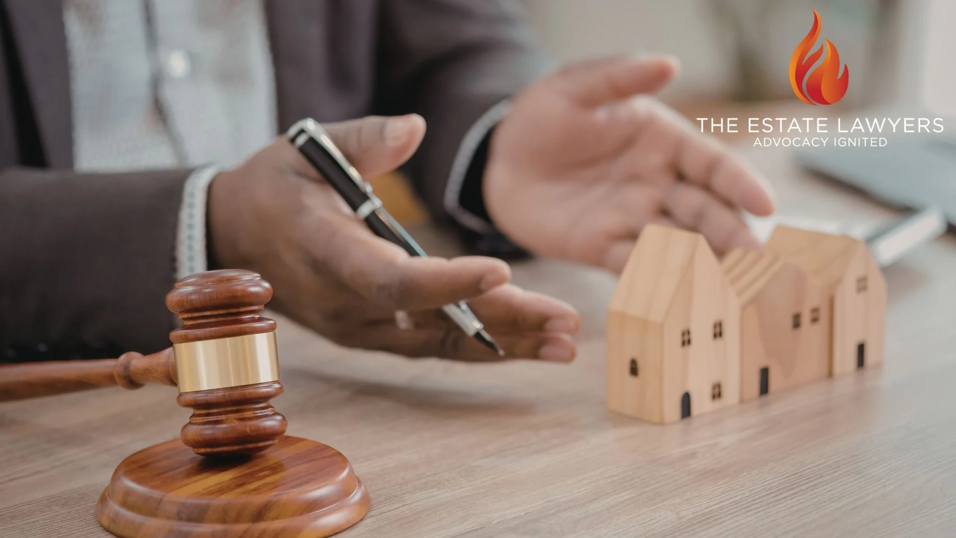 Estate lawyer discussing property with wooden house models