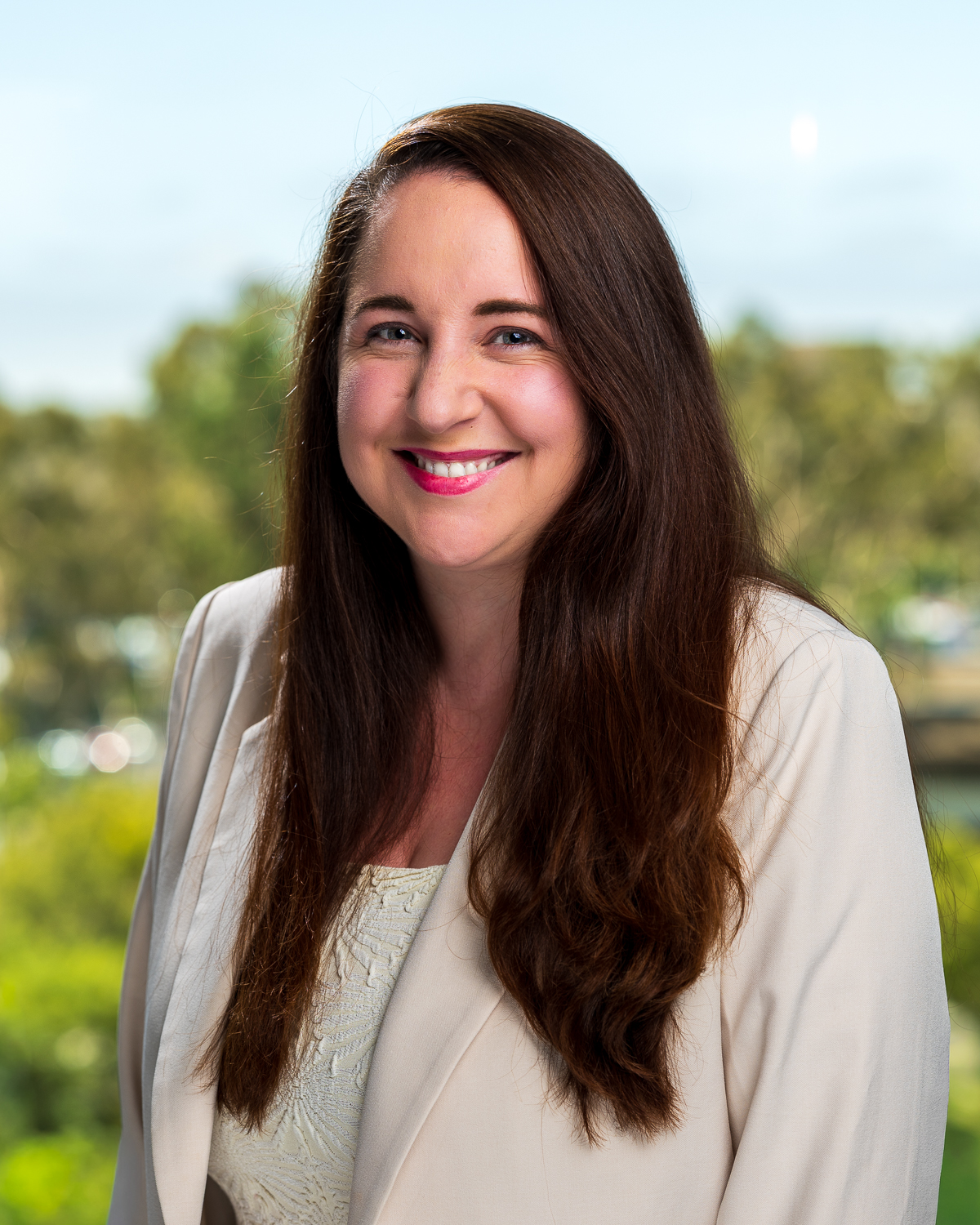 Smiling woman in blazer outdoors portrait