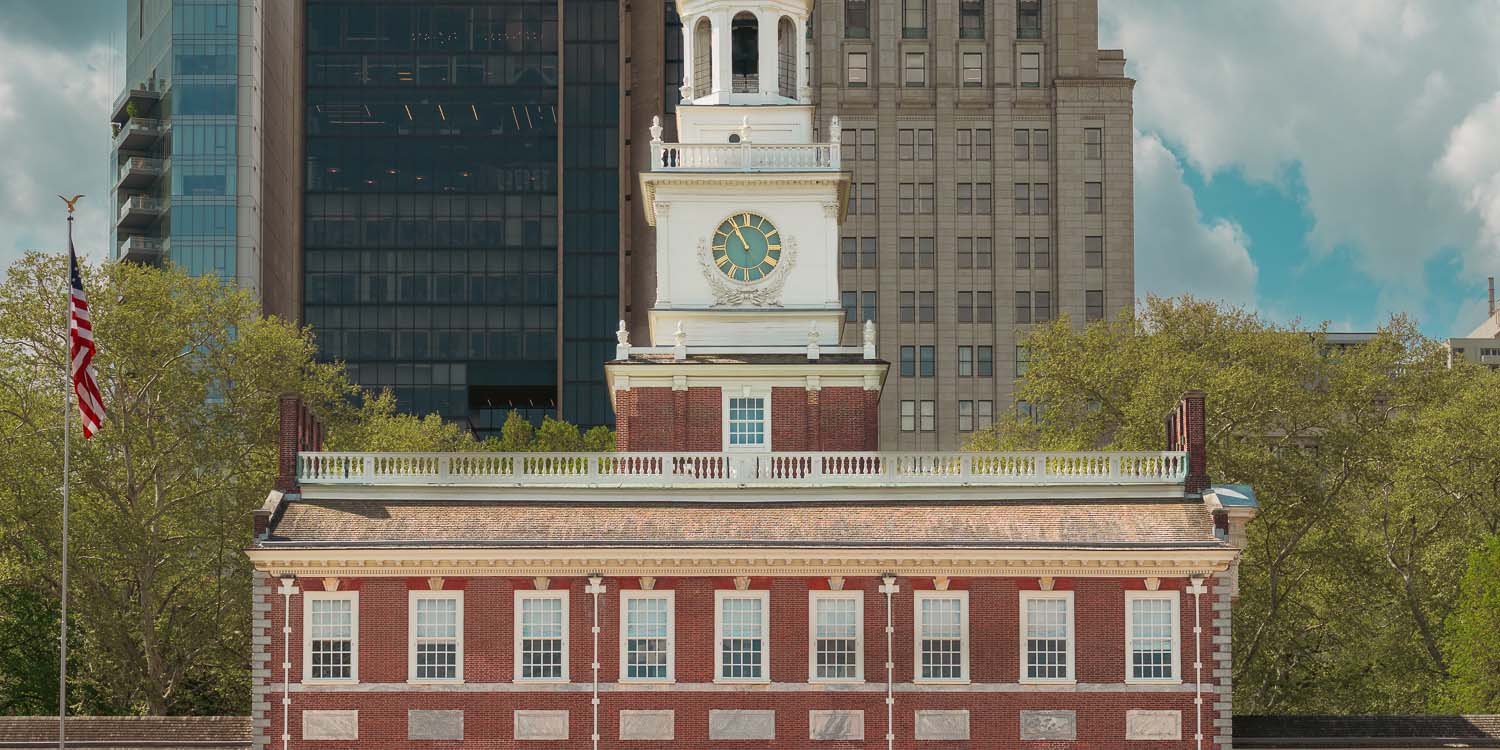 Independence Hall with clock tower and American flag